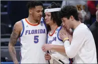  ?? (AP/Michael Conroy) ?? Florida guard Walter Clayton Jr. (center) is led off the court by teammates after Friday’s loss to Colorado.