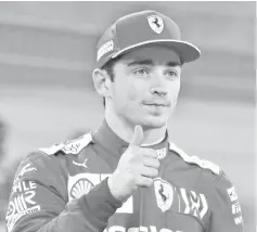  ??  ?? Ferrari’s Monegasque driver Charles Leclerc celebrates after taking his first ever pole position during the qualifying session ahead of the Formula One Bahrain Grand Prix at the Sakhir circuit in the desert south of the Bahraini capital Manama, on March 30, 2019. - The Formula One Bahrain Grand Prix will be held on March 31. - AFP photo