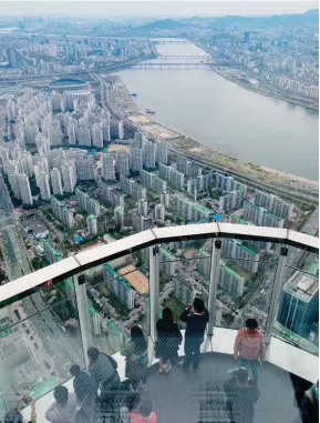  ??  ?? Above: Views over central Seoul and the Nam River from Korea’s highest observatio­n deck. Dubbed Seoul Sky, it is located 500 meters up the Lotte World Tower, which debuted in April as the country’s first supertall skyscraper.