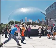  ?? STEVE MACNAULL PHOTO ?? The 110-tonne polished-stainless-steel Bean sculpture in Millennium Park has become Chicago’s No. 1 attraction.