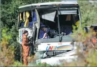  ?? JUSTIN TANG / THE CANADIAN PRESS ?? Provincial police officers inspect the site of a tour bus crash on Highway 401 West, near Prescott, Ontario, on Monday. The bus carrying Chinese tourists was traveling from Ottawa to Toronto on the province’s main highway when it veered off the road...