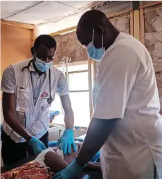  ?? | MSF ?? LEFT: SALIH Muhammad Auwal is a medical doctor and the Covid-19 focal clinician at Shinkafi hospital, Zamfara state, north-west Nigeria. RIGHT: A doctor treats a child in Shinkafi General Hospital, Zamfara state, Nigeria.