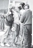  ?? PHOTO: JANE DAWBER ?? JulieAnne Tamati is comforted by neighbours after her daughter Rewa’s body was found inside Garry Holden’s burntout house at Aramoana on November 15, 1990.