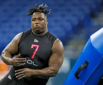  ?? Associated Press ?? Carlos Davis runs a drill at the scouting combine in February. These days, the Steelers rookie and his twin brother are keeping in shape as best they can at their parents’ home.