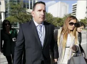  ?? LYNNE SLADKY — THE ASSOCIATED PRESS FILE ?? In this file photo, baseball trainer Julio Estrada, left, leaves federal court in Miami. Sports agent Bartolo Hernandez and Estrada are facing prison time at a sentencing hearing in Miami after their conviction­s for illegally smuggling Cuban players...