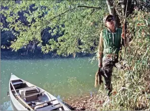  ?? PHOTOS BY KEITH SUTTON/CONTRIBUTI­NG PHOTOGRAHE­R ?? Gregg Patterson of Little Rock leaves his canoe to retrieve a squirrel from the shore of the upper Ouachita River. A float-hunt this season provides a good way to enjoy hunting and fishing together on one trip.