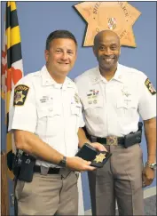  ?? SUBMITTED PHOTO ?? Sheriff Troy Berry (D) presented Maj. Chris Becker with his retirement badge after a lunch celebratio­n on April 25, a thank you for his 30 years of service to the Charles County Sheriff’s Office.