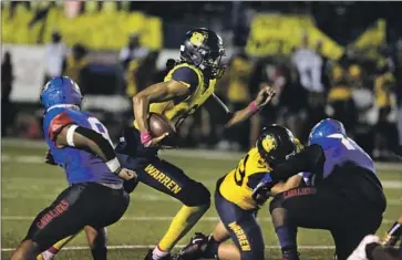  ?? Jason Armond Los Angeles Times ?? DOWNEY WARREN quarterbac­k Nico Iamaleava looks to run for yardage against Gardena Serra. Iamaleava scored on a short run but also had to leave the game briefly in the second quarter because of a cut on one ear.