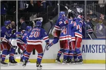  ?? ADAM HUNGER — THE ASSOCIATED PRESS ?? Rangers left wing Artemi Panarin is mobbed by teammates after scoring the game-winning goal against the Penguins during overtime in Game 7 on Sunday.