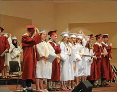  ?? NICHOLAS BUONANNO — NBUONANNO@DIGITALFIR­STMEDIA.COM ?? Members of the Stillwater High School Class of 2017 move their tassels to the other side after officially graduating Saturday.