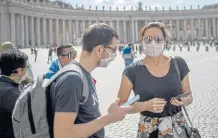  ?? /Getty Images/Antonio Masiello ?? Heart of Rome: Visitors wear masks as they attend the broadcast of Pope Francis’s prayer in Vatican City on Sunday.