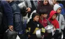  ?? ?? Displaced Palestinia­ns wait to collect food in Deir al-Balah, central Gaza Strip. Photograph: Majdi Fathi/NurPhoto/ Rex/Shuttersto­ck