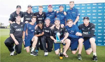  ??  ?? NELSON: New Zealand players pose with the ODI series trophy after winning the third one day internatio­nal cricket match between New Zealand and Bangladesh at Saxton Oval in Nelson yesterday. — AFP