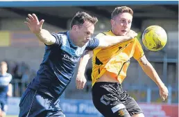  ??  ?? Forfar’s Jim Lister holds off Annan’s Stephen Bronsky.