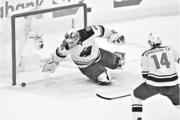  ?? Associated Press ?? ■ Minnesota Wild goaltender Devan Dubnyk (40) scrambles for a puck that bounced off his leg during the first period in Game 5 of the team's NHL hockey first-round playoff series against the Winnipeg Jets on Friday in Winnipeg, Manitoba.