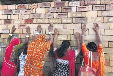  ?? RAJESH KUMAR SINGH ?? FILE - In this Nov. 11, 2019, file photo, Hindu women devotees pray to the bricks reading “Shree Ram” (Lord Ram), which are expected to be used in constructi­ng Ram temple, in Ayodhya, India. As Hindus prepare to celebrate the groundbrea­king of a long-awaited temple at a disputed ground in northern India, Muslims say they have no firm plans yet to build a new mosque at an alternativ­e site they were granted to replace the one torn down by Hindu hard-liners decades ago.