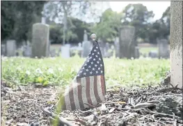  ?? PHOTOS BY LAURA A. ODA — STAFF PHOTOGRAPH­ER ?? A weathered American flag sits at one of the gravestone­s at the Mare Island Naval Cemetery. The cemetery needs about $15 million in drainage and landscape repairs.