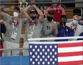  ?? GREGORY BULL - THE ASSOCIATED PRESS ?? Simone Biles, of the United States, and teammates cheer as Jade Carey receives the gold medal for the floor exercise during the artistic gymnastics women’s apparatus final at the 2020Summer Olympics, Monday, Aug. 2, 2021, in Tokyo, Japan.