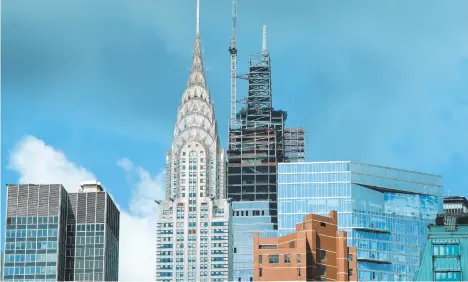  ?? TIMOTHYA.CLARY/GETTY-AFP ?? The Chrysler Building stands next to One Vanderbilt in 2019 as it tops out at 1,401 feet, becoming the tallest office building in Midtown, NewYork.