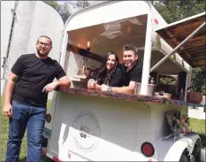  ?? Arnold Gold / Hearst Connecticu­t Media ?? From left, Andrew Boyle, Sarah Currie and her husband Nick Currie, owners of the Pours & Carriage Mobile Bar Company, are photograph­ed with the converted horse trailer in Orange on Friday.