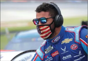  ?? PHOTOS BY CHRIS GRAYTHEN/GETTY IMAGES/TNS ?? Above: Bubba Wallace prepares for the GEICO 500 at Talladega Superspeed­way on Monday in Talladega, Ala. A noose was found in his garage stall a week after the organizati­on banned the Confederat­e flag at its facilities. Below: Ryan Blaney celebrates in Victory Lane.