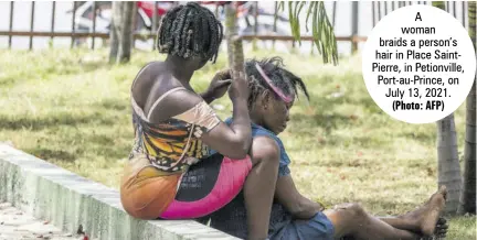  ?? (Photo: AFP) ?? A woman braids a person’s hair in Place Saintpierr­e, in Petionvill­e, Port-au-prince, on July 13, 2021.