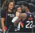  ?? MICHAEL CHOW/ARIZONA REPUBLIC ?? The Suns’ Deandre Ayton kisses his son, Deandre Jr., with his girlfriend Anissa Evans watching after winning Game 2.