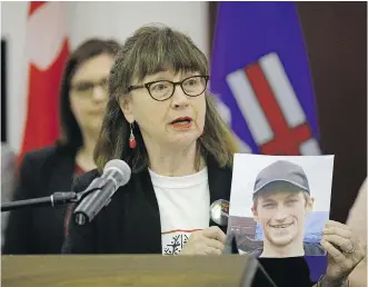 ?? LARRY WONG ?? Lorna Thomas holds a photo of her son Alex Thomas — who died in 2012 — at the Alberta legislatur­e on Wednesday, when the province announced an emergency commission to help respond to the opioid crisis.