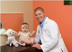  ??  ?? Pediatrici­an Dr. David Butler and patient