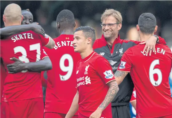  ??  ?? Liverpool manager Juergen Klopp, second right, celebrates with his players including goalscorer­s Philippe Coutinho, third right, and Christian Benteke, No.9.
