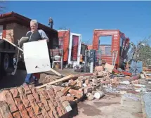  ?? ROD AYDELOTTE, AP ?? Renea Parnell removes a relative’s belongings Monday near Whitney, Texas. A possible tornado hit the area Sunday.