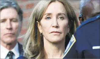  ?? Michael Dwyer / Associated Press ?? Felicity Huffman leaves federal court with her brother Moore Huffman Jr., after she was sentenced in a nationwide college admissions bribery scandal, Friday in Boston.
