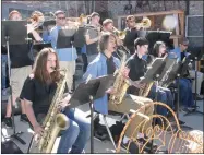  ??  ?? Prairie Grove High jazz band set up outside next to Daisies & Olives and entertaine­d visitors downtown for Trades Day.