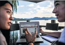  ?? PROVIDED TO CHINA DAILY ?? Yanis (right), who is from Turkey and goes by just one name, browses Tmall with his girlfriend. Yanis likes to buy Chinese snacks online.