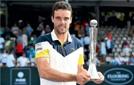  ?? GETTY IMAGES ?? Roberto Bautista Agut with his ASB Classic trophy after he beat Juan Martin Del Potro, left, 6-1 4-6 7-5 in the final on Saturday.