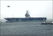  ?? ?? The aircraft carrier USS George Washington makes its way up the Elizabeth River through the rain and fog to its home port Dec. 20, 2002, in Norfolk, Virginia.