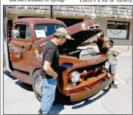  ?? (NWA Democrat-Gazette/Mark Humphrey) ?? Antonio Jordan (from left), Jorge Jordan and Sandro Jordan, 10, look over a 1951 Ford Truck Dually owned by Jonathan Odom on June 25 as they arrive at the 11th annual Chicken Rod Nationals held on the Lincoln Square. The Summers’ trio marveled at the diesel motor with Jorge noting, “You don’t usually see a diesel engine in an older vehicle.” The truck won an award for “Least Original” at the show.