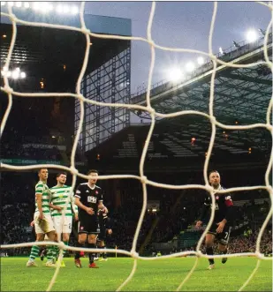  ??  ?? Ryan Christie notches a second goal for Celtic yesterday but a protesting section of the fans were still far from happy (above left)
