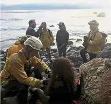  ??  ?? Lucky escape: Rescue personnel attending to Hernandez after she was found at the bottom of a cliff in Monterey County, California. — Reuters