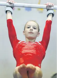  ?? CLIFFORD SKARSTEDT/EXAMINER ?? Kawartha Gymnastics' Chloe Hannam, 15, warms up on the uneven bars last week at Kawartha Gymnastics Club. Hannam will compete with Team Ontario at a major event in California. See more photograph­s in the online gallery at www.thepeterbo­roughexami­ner.com.