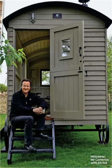  ??  ?? Shed of State: Mr Cameron poses in his garden with his £25,000 shepherd’s hut Hideaway: Mr Cameron with his hut