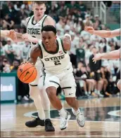  ?? CARLOS OSORIO — THE ASSOCIATED PRESS ?? Michigan State guard Tyson Walker (2) drives through Iowa during the second half of Tuesday’s game in East Lansing.