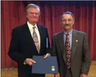  ??  ?? Assemblyma­n John Salka, right, presents a proclamati­on to Ralph Holmes of Ralph’s Collision at the 2019Chambe­r Annual Dinner at the Kallet Civic Center on Friday, Nov. 1, 2019.