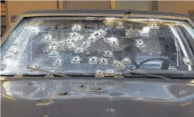  ?? Picture: john kuntz, tony dejak / aP ?? Police bullet holes pepper the windscreen of the Chevrolet Malibu