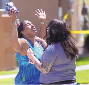  ?? ADOLPHE PIERRE-LOUIS/JOURNAL ?? Minister Laura Bobbs, left, is comforted by Amanda Wilson after arriving at the apartment complex where her 10-year-old goddaughte­r had been found dead earlier Wednesday.