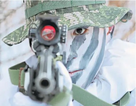  ??  ?? A South Korean marine during a joint winter drill with US marines in Pyeongchan­g. It is feared Kim Jong-un, below left, will target the 2018 Winter Olympics in South Korea