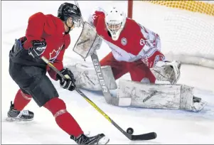  ?? CP PHOTO ?? Team Canada’s Brett Howden moves in on Team Denmark goalie Mads Sogaard who makes the save during World Junior exhibition hockey action at the Canadian national junior hockey team selection camp, in St. Catharines, Ont., on Friday.