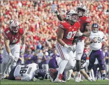  ?? [MORRY GASH/THE ASSOCIATED PRESS] ?? Wisconsin’s Isaiahh Loudermilk, center, and Leon Jacobs celebrate a sack during Saturday’s game.