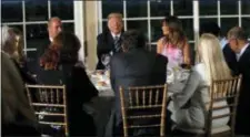  ?? CAROLYN KASTER — THE ASSOCIATED PRESS ?? President Donald Trump sits with first lady Melania Trump as he meets with business leaders, Tuesday at Trump National Golf Club in Bedminster, N.J.