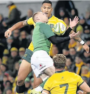  ?? Picture: AFP ?? HIGH AND SURE: Ireland's Keith Earls (in green) takes the high ball in front of Australian Wallabies player Israel Folau during the second Test between the two nations in Melbourne last weekend